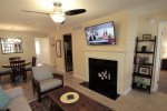 Living room with wall mounted flat screen HDTV and decorative fireplace